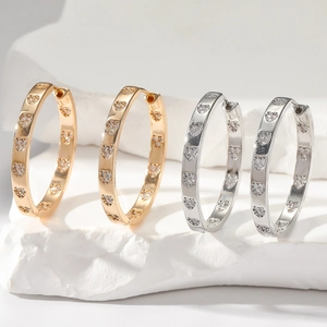 Minimalist heart-shaped diamond hoop earrings in gold and silver finish on white stones