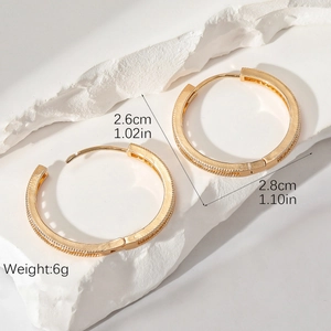 Gold textured hoop earrings with zirconia accents showing 2.8cm diameter dimensions
