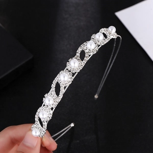 Elegant bridal silver headband with delicate pearls and crystals for wedding hairstyle