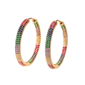 Detail of large gold hoop earrings with multi-colored cubic zirconia pavé stones