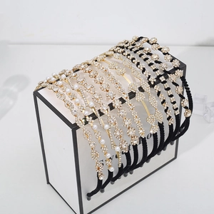 Elegant rhinestone and pearl headbands displayed on a premium black and white showcase