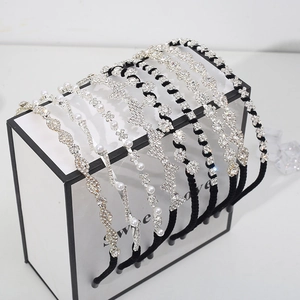 Eight trendy women's headbands with white pearls and sparkling rhinestones on display