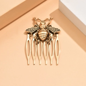 Vintage gold metal hair comb featuring detailed honeybee design with five smooth teeth