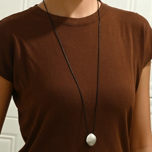 Minimalist silver teardrop pendant on black leather cord necklace for party wear