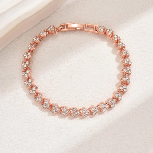 Detail of rose gold bracelet featuring heart motifs and sparkling cubic zirconia stones