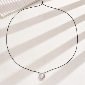 Minimalist silver teardrop pendant on black cord necklace with mirror finish on white stone