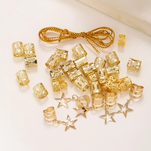 Macro view of gold star pendant hair rings and braided metal cuffs for hair decoration