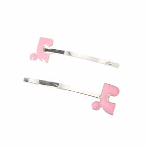 Detail view of pink enamel geometric hair clips on silver metal base for women