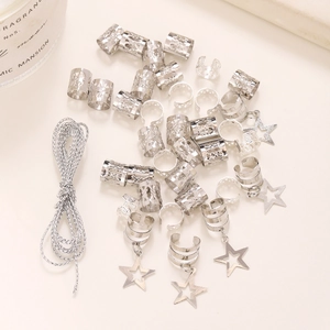 Detailed macro view of silver star charms and hollow hair cuffs for dreadlocks styling