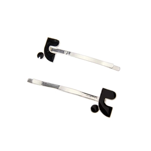 Detail view of silver hair clips with black enamel geometric shapes and 925 stamp