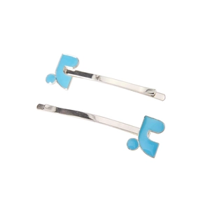 Detailed macro view of two silver hair clips with light blue enamel note shaped design
