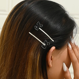 Set of 2 elegant black drip oil geometric hairpins shown on a model side profile