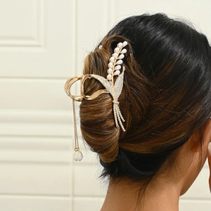 Elegant gold lily of the valley hair claw with pearls and sparkling rhinestone tassels