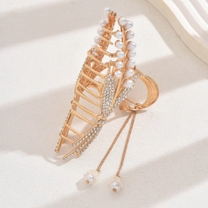Elegant gold hair claw clip with rhinestones, pearls and tassels in a leaf design