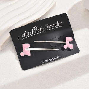 Pair of stylish pink oil-dripping musical note hair clips on elegant display card