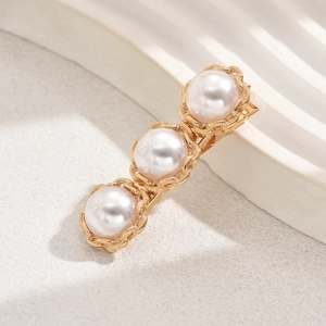 Elegant gold metal hair clip featuring three large white pearls in vintage floral frames