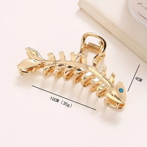Elegant golden fishbone hair claw clip with blue rhinestone embellishment for women