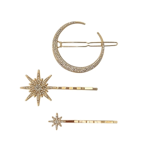Detail showing vintage gold star and moon hair clip set with sparkling rhinestones