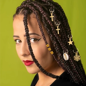 Detail of DIY braid accessories set with golden metal rings and pendants for hair