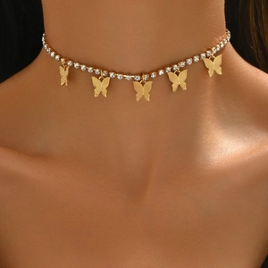 Golden Cuban butterfly choker necklace with rhinestones worn on a model's neck