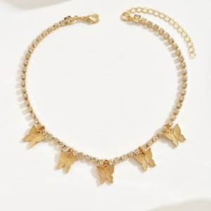 Close-up of golden Cuban chain with sparkling rhinestones and five butterfly pendants