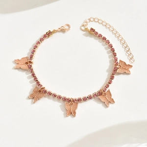 Detailed close-up of gold butterfly bracelet with pink rhinestones and adjustable lobster clasp
