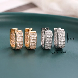 Micro paved zircon huggie earrings in gold and silver finish with size indicators