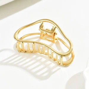 Polished gold metal hair claw clip featuring elegant hollow cloud design and sleek shadow effects