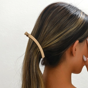 Minimalist gold metal hair clip with elegant curved lines for women ponytail styling
