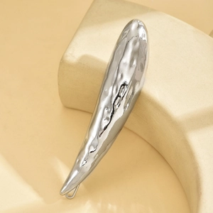 Irregular silver lava metal hair clip with a hammered texture and minimalist design