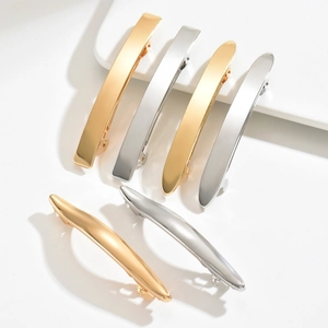 Minimalist metal hair clips set in gold and silver finishes with matte and glossy textures