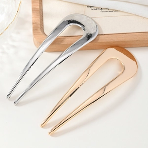 Minimalist U-shaped metal hair pins in gold and silver finish with polished surface