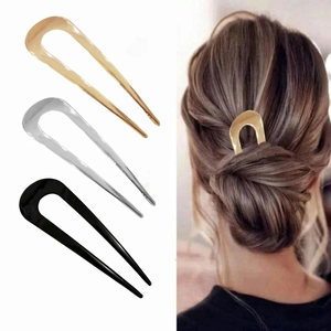 Minimalist metal U-shaped hair pins in gold silver and black shown on a model