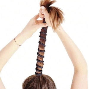 Black braided elastic hair tie shown holding a high ponytail on brown hair with spiral wrap