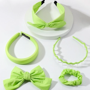 Detailed set of fluorescent green fabric hair accessories including headbands and hair bows