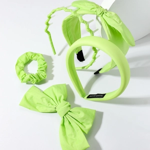 Detail view of fluorescent green hair accessory set including headband, clip, and scrunchie