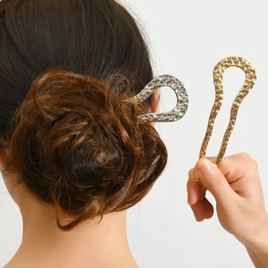Elegant gold and silver U-shaped metal hair pins with textured hammered finish