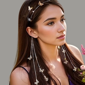 Elegant gold butterfly headband with tassels and rhinestones on a female model