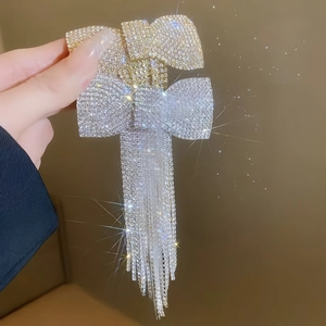 Barrette à cheveux élégante avec nœud en strass et long pompon en cristal brillant