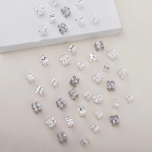 Detailed close-up of 40 pieces of vintage silver dreadlock hair rings with hollow patterns