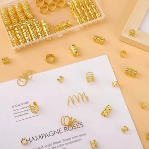 Close-up of golden dreadlock jewelry set with metal cuffs and storage box organizer