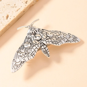 Vintage moth hair clip in retro silver metal with gothic skull and moon wing engravings