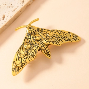 Vintage moth metal hair clip with mystical moon patterns and antique gold finish