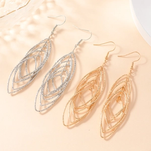 Textured gold and silver multi-layer hollow leaf earrings shown on minimalist background