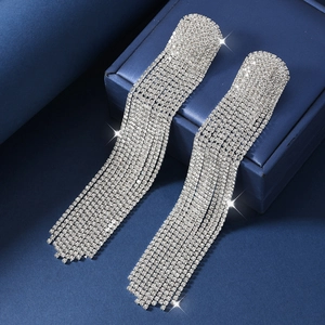 Exaggerated long fringe tassel earrings with silver rhinestones on a blue jewelry box