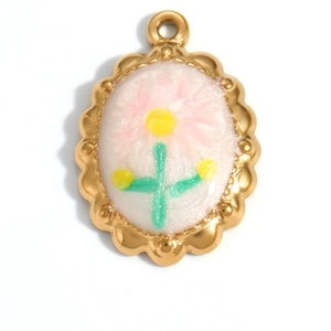 Detail of scalloped gold oval pendant with hand-painted pink flower and white inlay