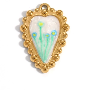 Macro detail of a gold heart pendant with floral enamel inlay and beaded edge craftsmanship
