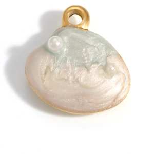 Detail of a gold-plated shell pendant with mint green enamel and faux pearls for DIY jewelry