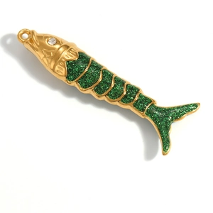 Detailed macro shot of a fish charm with green glitter filling and 18K gold plating