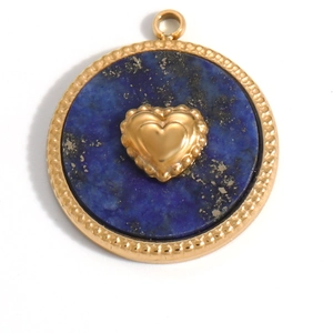 Detailed macro of 18K gold plated blue lapis lazuli round pendant with a gold heart center